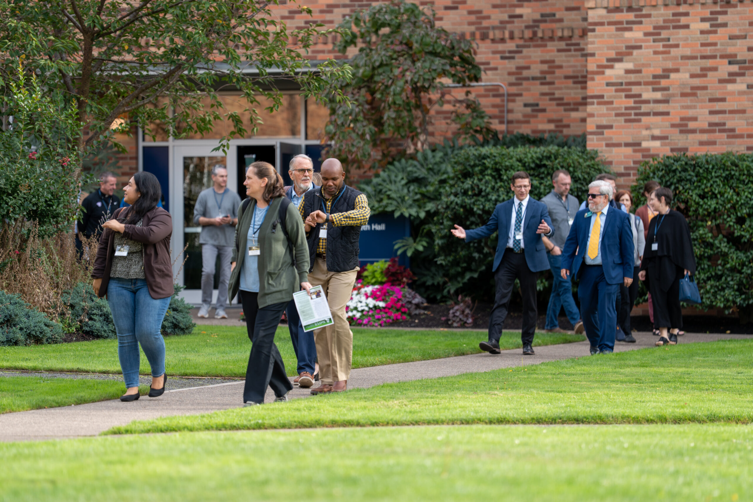 A group of participants walking across campus during the 2025 NetVUE regional gathering at Bushnell University.